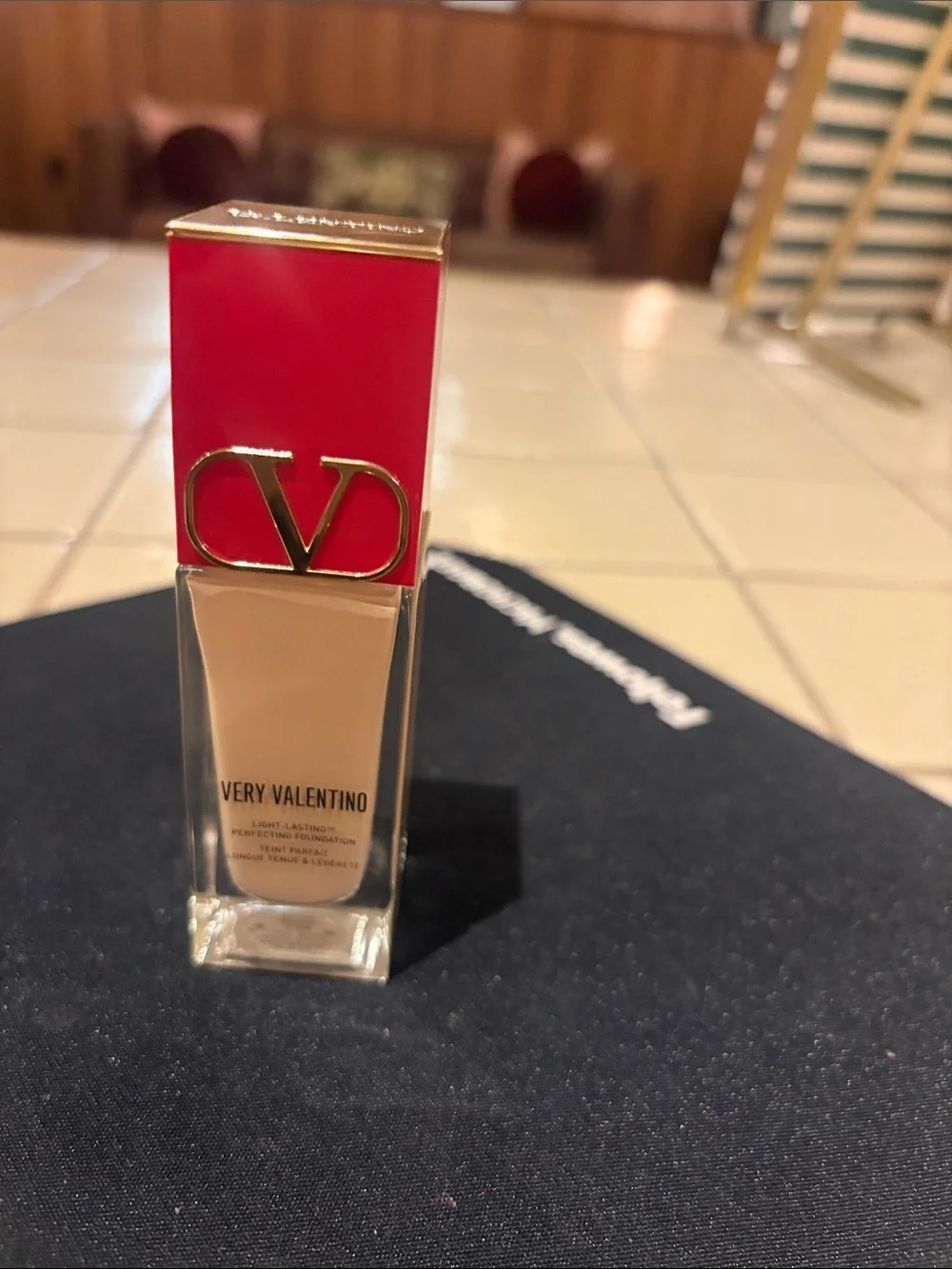 Valentino foundation bottle with red cap and beige serum LN4